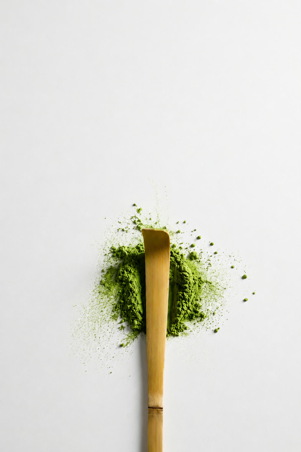 Uji Ceremonial Matcha — bamboo scoop on a mound of matcha powder