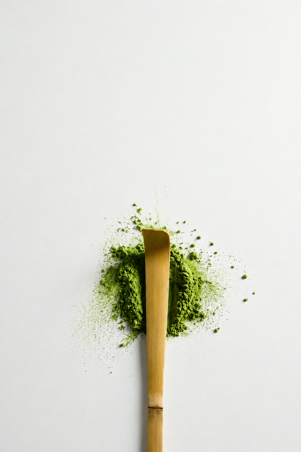 Uji Ceremonial Matcha — bamboo scoop on a mound of vibrant matcha powder