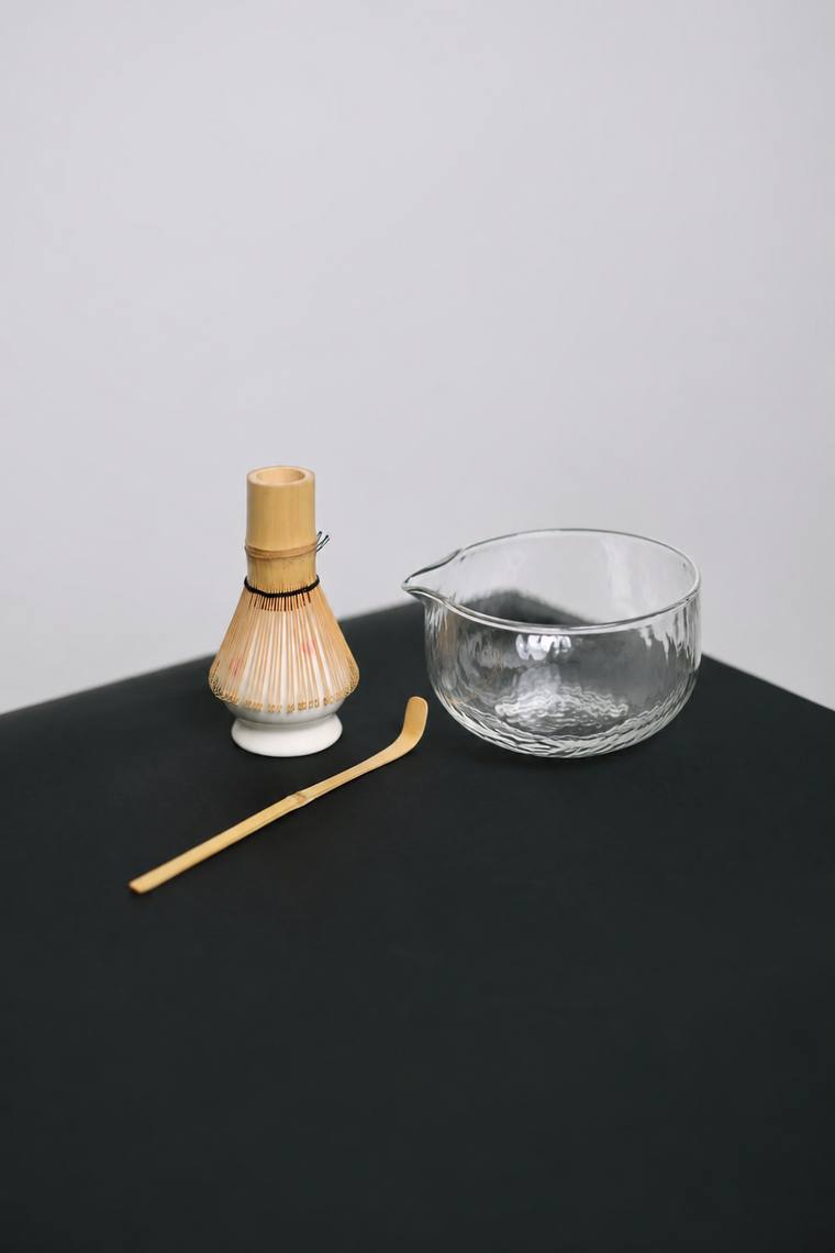 The Crystal Set — hammered glass spouted bowl, bamboo whisk on its ceramic holder, and a bamboo scoop